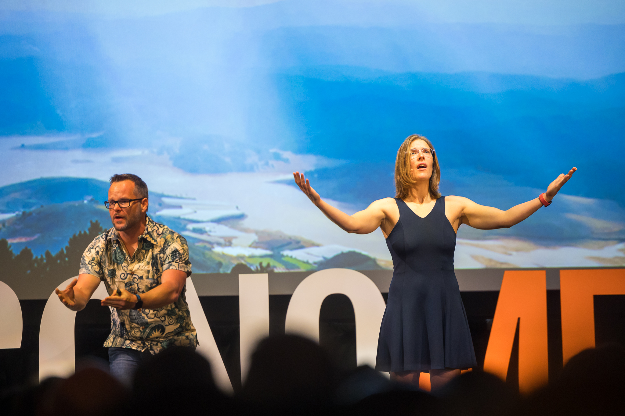 econome-2024-financial-independence-talk-stage Alan Donegan and Katie Donegan on stage at EconoMe 2024 delivering a financial independence talk to the FI community.