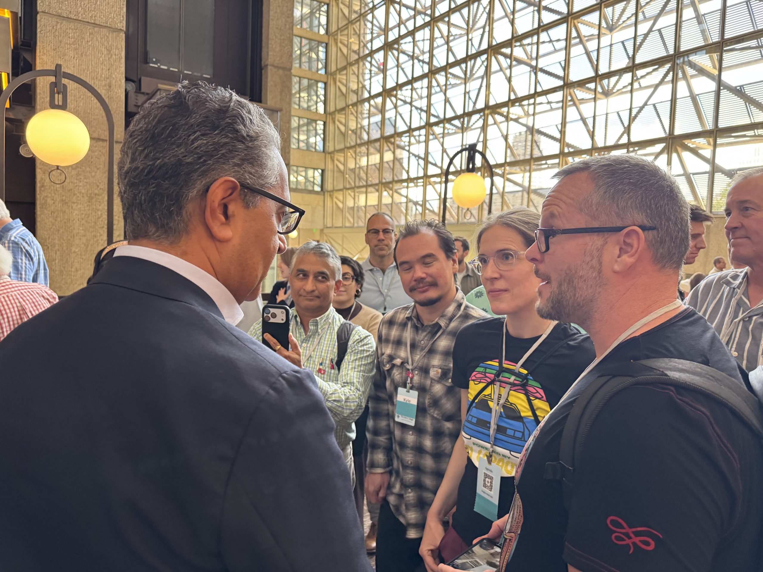 Katie and Alan Donegan meeting Vanguard CEO Salim Ramji at Bogleheads Conference 2025, smiling together after a keynote session.